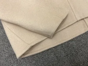 Close-up of beige double-sided wool top showing premium fabric texture and neat stitching