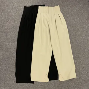 High-waist wide-leg trousers in black and beige with drape pleats and side hem slits