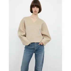 Minimalist beige V-neck wool sweater with oversized drop shoulders and premium loose fit