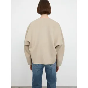 Minimalist beige wool blend loose jacket with a collarless back view and denim pairing
