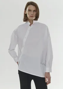 Detail of white cotton shirt showing asymmetric diagonal button placket and stand collar