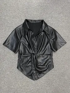 Detailed view of the gathered waist and faux leather texture on black V-neck short sleeve shirt