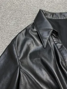 Close-up of the lapel and stitching on this high-quality black faux leather short sleeve shirt