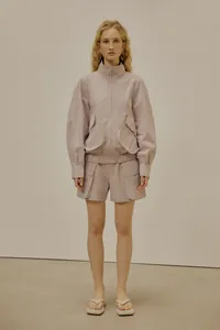 Detail of lilac purple tech fabric utility jacket with large pockets and matching shorts