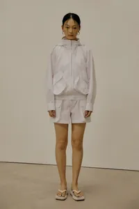 White minimalist hooded jacket and shorts set with large utility pockets