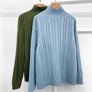 Detailed view of the rib-knit texture and turtlenecks of light blue and olive sweaters
