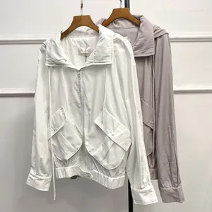 Detailed close-up of zipper, drawstring hood, and large pockets on a casual jacket