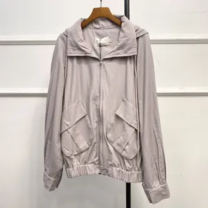 Detail view of large utility pockets and zipper closure on a lilac hooded jacket