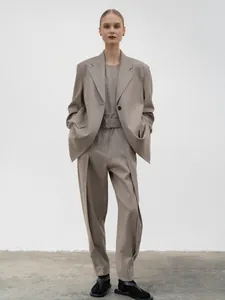Modern light brown three-piece suit set featuring a loose blazer and high-waisted trousers