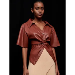 Brown faux leather V-neck short sleeve shirt with twist waist detail and button closure