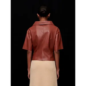 Women's faux leather short sleeve top with V-neck knot design in brick red, back view