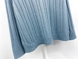 Close-up of light blue ribbed knit sweater showing detailed texture and hem finish