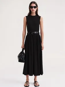 Détail d'une robe longue noire sans manches avec taille cintrée et fine ceinture en cuir