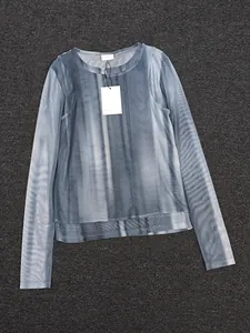 Detail view of semi-transparent blue tie-dye mesh long sleeve top with crew neck