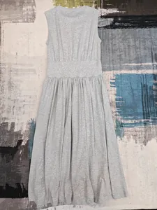 Détail à plat d'une robe grise sans manches en tricot avec taille haute plissée