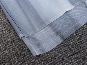 Detail view of grey-blue breathable mesh fabric with reinforced double-stitch hem