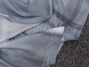 Macro detail of breathable dual-layer blue mesh fabric with professional flatlock stitching