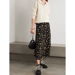 Chic floral midi skirt with buttons paired with a cream knit sweater and boots
