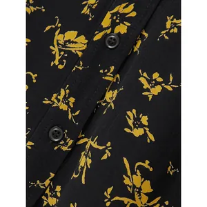 Floral black high-waisted midi skirt with yellow flower patterns and button details