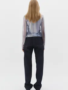 Back view of light blue mesh long sleeve top paired with dark indigo straight-leg denim jeans