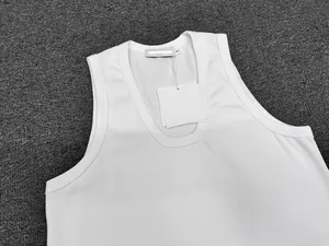Detail view of the white sleeveless vest showing the U-neckline and inner S-size label