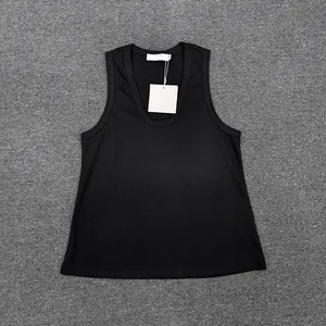 Close-up of black sleeveless knit tank top with U-neckline and white brand tag on grey rug