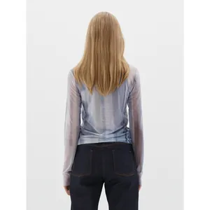Women's light blue sheer mesh long sleeve top and dark blue denim jeans outfit