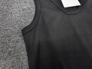 Close-up of black sleeveless cotton vest with U-neckline and detailed stitching