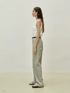 Side view of white sleeveless tank top and black striped high waist straight trousers