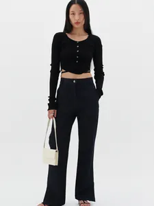 Detail view of black V-neck ribbed knit cardigan with criss-cross waist ties and buttons