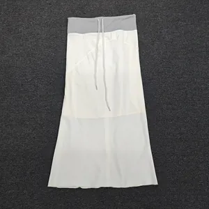 Detail view of high-waist drawstring design on two-tone grey and white midi skirt