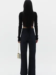 Detail of slim fit ribbed knit cardigan with elegant back lace-up design in black color