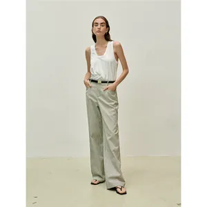 Minimalist white U-neck sleeveless tank top with striped wide-leg trousers and black belt