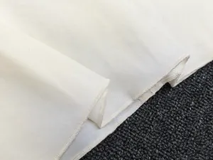 Detail shot of ivory white midi skirt fabric with high-quality edge overlock stitching