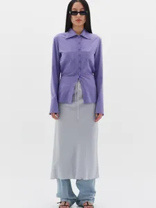 Detail view of light purple long sleeve button shirt with large pockets and drawstring skirt