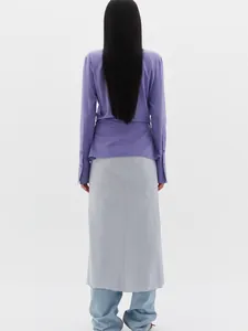 Detail view of purple slim shirt sleeves and layered light grey maxi skirt