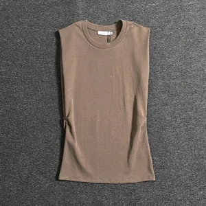 Close-up of pleated waist detail on khaki sleeveless round neck top with smooth cotton texture