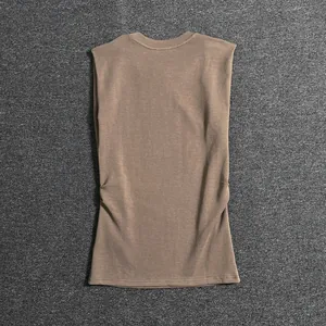 Detailed flat lay of an earth tone sleeveless padded shoulder vest in cotton blend fabric
