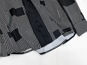 Detail of geometric line pattern on the hem and cuff of a long-sleeved shirt