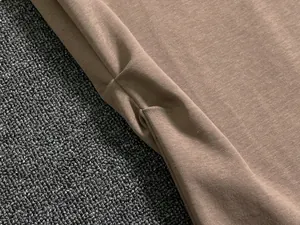 Detailed macro shot of khaki knit fabric stitching and fine texture on a women's set