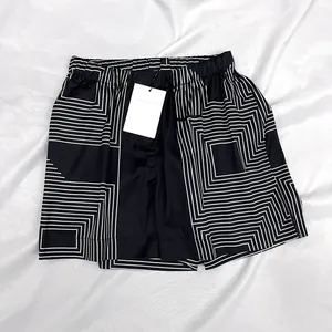 Macro detail of geometric patterned satin fabric on shorts with elastic waistband