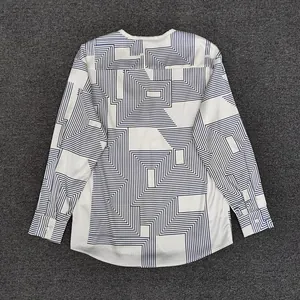 Detail of geometric line print on loose long-sleeve shirt with smooth fabric texture