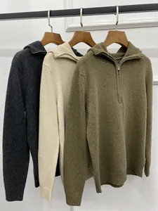 Detailed view of the textured knit fabric and metal half-zipper on hooded sweaters