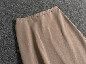Detailed view of light brown knit midi skirt with elastic waist and fine texture