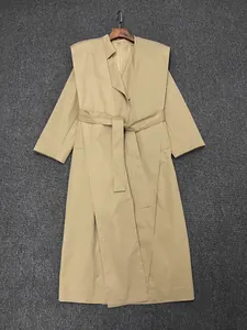 Detail view of khaki long trench coat with wide overlapping collar and matching waist belt