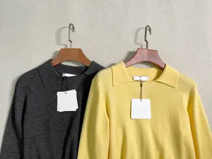 Detail shot of long-sleeved polo knit tops in grey and yellow with fine ribbed texture