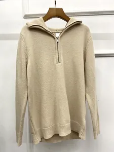 Detail of the high-quality half-zip collar and ribbed knit texture on oat sweater