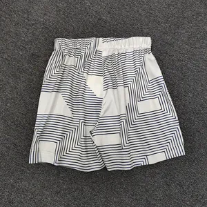 Detail of casual shorts featuring navy geometric V-pattern and elastic waistband