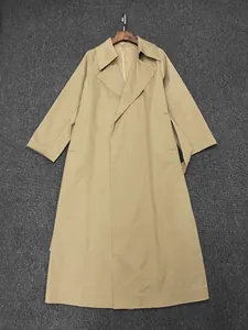 Close-up of khaki trench coat fabric featuring wide lapels and premium stitching details