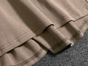 Detail of double-needle stitching and interlocking seams on coffee knit skirt set hem